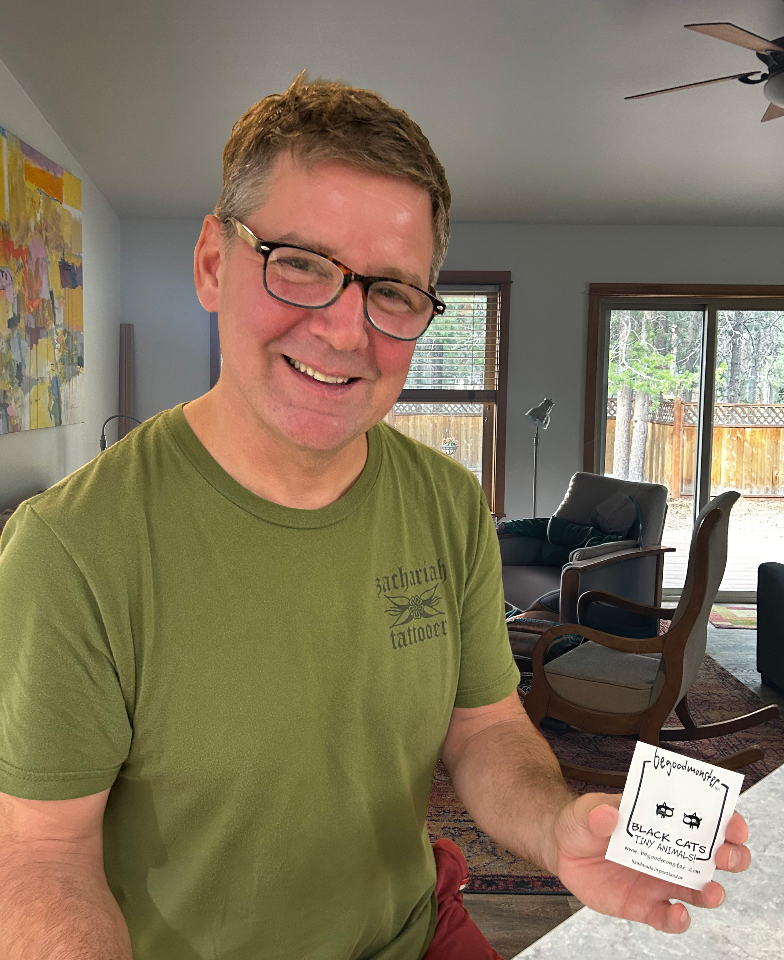 Artist Matt Wayne displaying a finished pair of Be Good Monster Earrings.